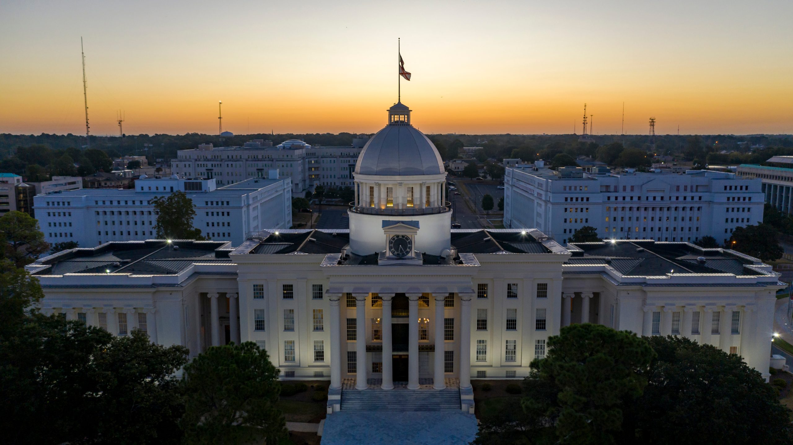 Golden sunlight reaches the horizon showing around the capital building in Montgomery Alabama